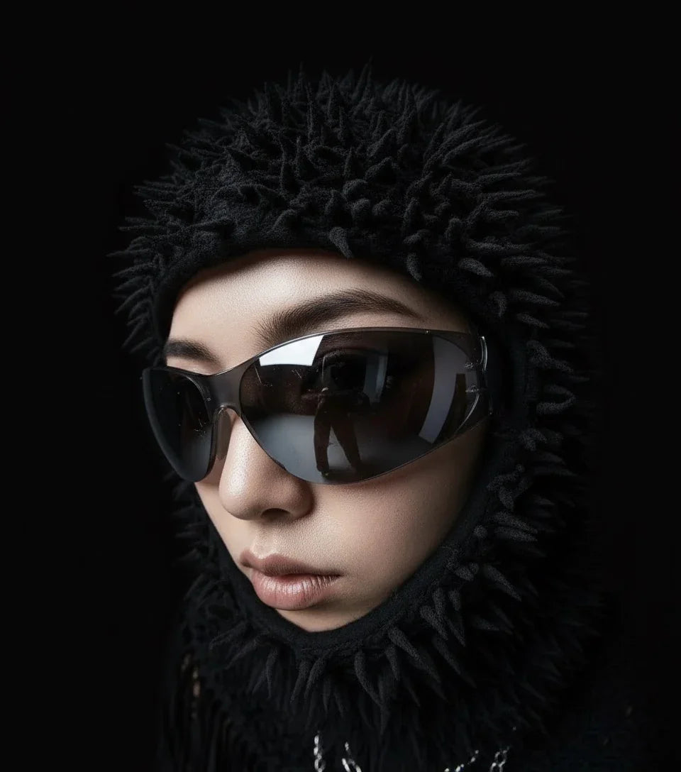 Model in edgy opium fashion, wearing spiked black hood and sleek sunglasses, Affect—Crew style
